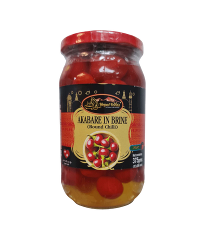Jar of Akabare in Brine round chillies with a visible brand label on a white background.