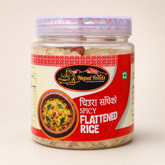 A jar of Nepal Foods Spicy Flattened Rice (Chura Sakhko) on a light beige background. The product is packaged in a clear plastic jar showing the beige rice grains inside, with a red and cream label featuring a picture of the prepared dish.