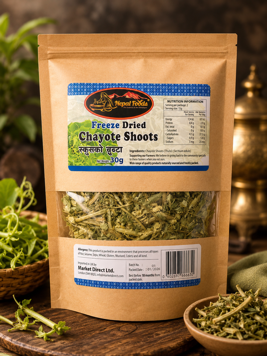 A stand-up pouch of Nepal Foliar Freeze Dried Chayote Shoots, displayed on a rustic wooden surface with fresh greens and a bowl of dried chayote in the foreground.
