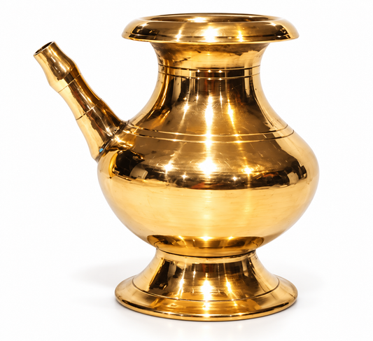 A polished brass traditional mug with a flared rim, a curved spout, and a pedestal base, shown on a white background. Puja Karuwa.