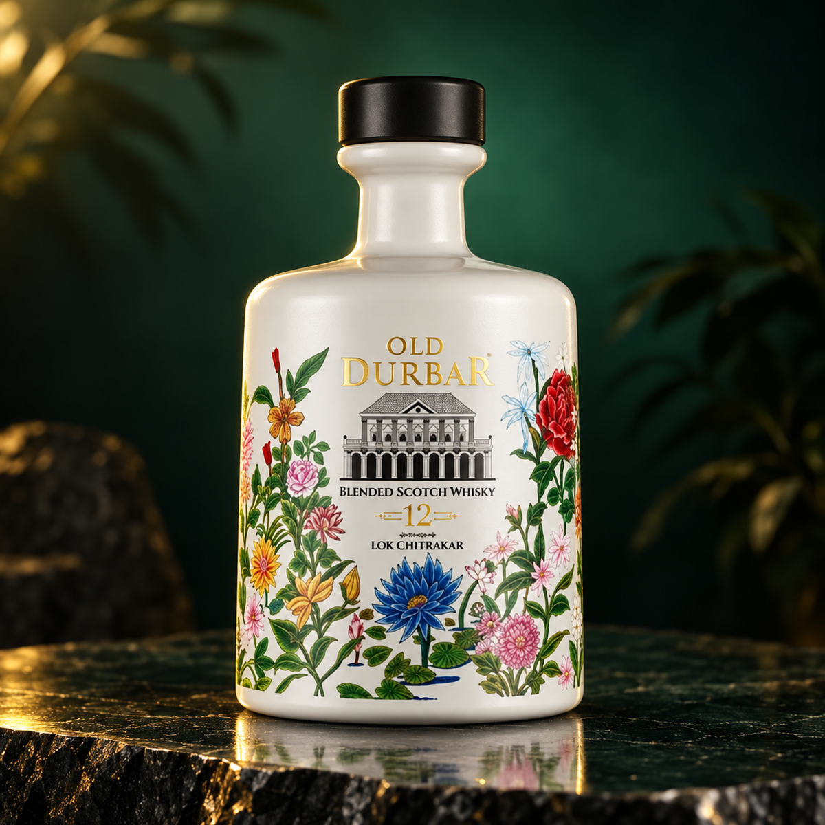 A bottle of Old Durbar 12 Year Lok Chittakar blended Scotch whisky, decorated with colorful botanical illustrations, resting on a dark polished stone surface with a dark green background.