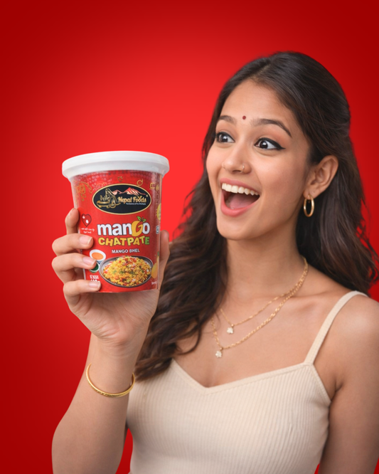 Woman holding a container of Mango Chatpata against a red background